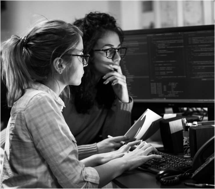 Two women working together on a desktop