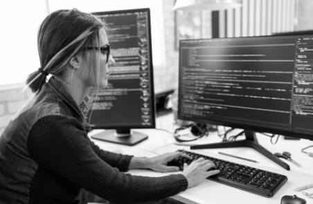 Woman Coding at Desktop