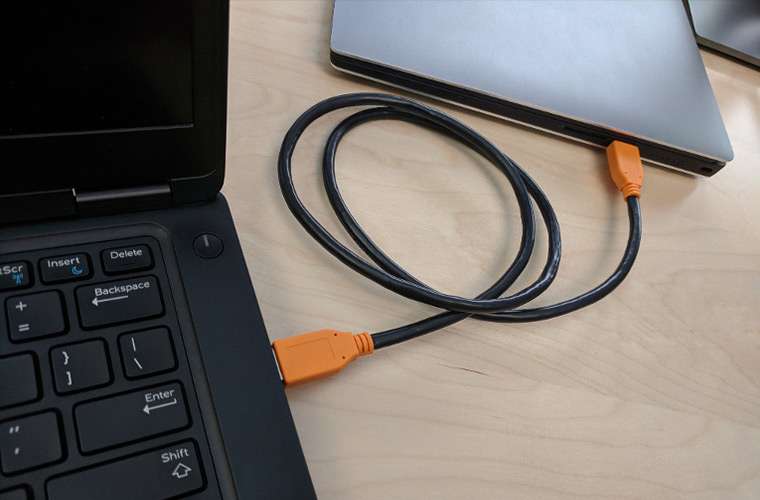Two laptops connected via USB cable